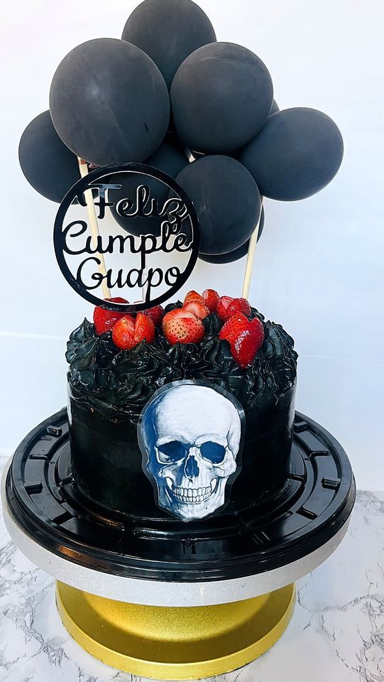 Black cake with skull and balloons in Playa del Carmen